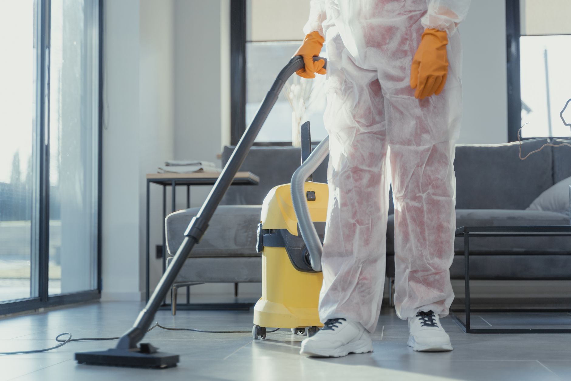A close-up of a mold remediation technician using an air scrubber to purify the air in a contained area of a Kennedale home.